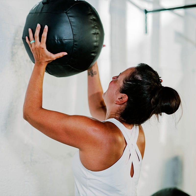 Woman training with wall ball